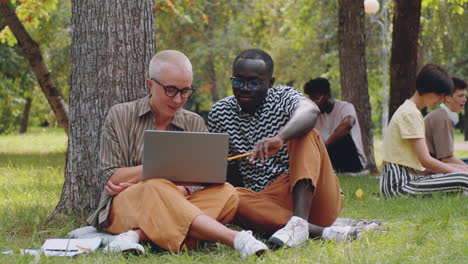 Portrait-of-Multiethnic-Student-and-Teacher-with-Laptop-in-Park